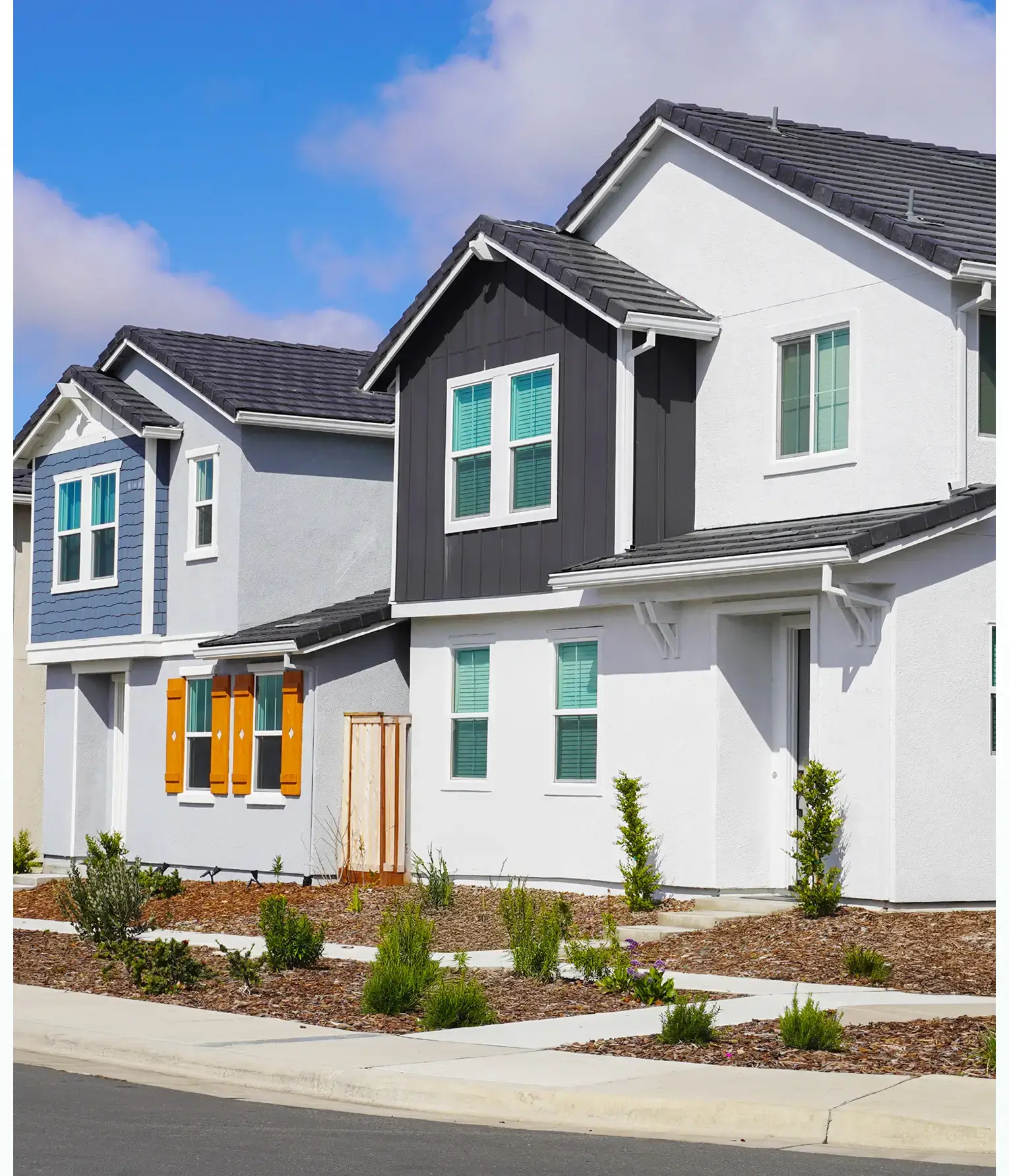 Modern suburban houses with landscaped front yards.
